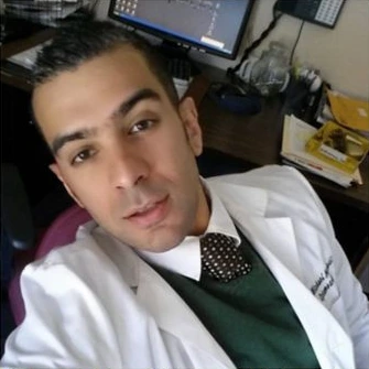 Dr. Michael Morshedi, OD, wearing a white coat in the practice-supplied biography photograph